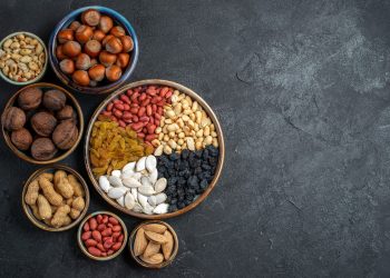 top-view-different-nuts-with-raisins-dried-fruits-grey-background-nut-snack-raisin-dry-fruit-nuts_140725-64625